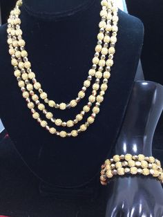 "Fabulous Trifari set all done on brilliant gold plated metal. The necklace and bracelet are both three strands of gold Aurum crystals and round gold nugget beads with nubbins all over them. Necklace measuring 18\" by 1\"and the bracelet measuring 7 1/2\" by 1\". This set has a great rich feel to it and very weighty! ABSOLUTELY GORGEOUS!" Three Strand Necklace, Gold Nugget, Necklace And Bracelet, Strand Necklace, Jewelry Sets, Pearl Necklace, Gold Plate, Bracelet, Beads