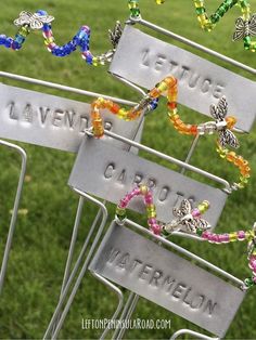 a bunch of metal signs sitting on top of a grass covered field next to each other