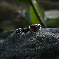 Our adjustable garnet heart rose ring is a intricate statement piece that combines the charm of the Victorian era with a macabre gothic twist. 🖤 🦇  The centerpiece of this romantic Victorian ring is a stunning red garnet heart, symbolizing deep love, passion, and devotion. ♥️ 🥀  This stunning ring is the perfect accessory for anyone who loves gothic, boho, or witchy jewelry. The vintage Victorian vampire design is both elegant and eerie, making this ring a truly unique statement piece. ️ 💍 T Red Goth Jewelry, Goth Wedding Ring Set, Gothic Garnet Jewelry For Gift, Gothic Rings For Valentine's Day Gift, Valentine's Day Gothic Rings As Gift, Gothic Heart-shaped Anniversary Jewelry, Goth Promise Ring, Gothic Rings Aesthetic, Vampire Jewelry Aesthetic