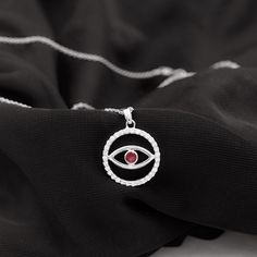 Product Details The Evil Eye Pendant is a striking piece of jewelry that exudes just the perfect level of allure and makes an excellent present for someone special. The Eternity Pendant Necklace showcases a Round Shape Ruby that sits in a Bezel Setting at the center of the Eternity Circle. The circle is embellished with Brilliant Cut Diamond, creating a stunning and refined appearance. Wearing this pendant will elevate your outfit and bring a touch of sophistication to your overall look. Product The Evil Eye, Overall Outfit, Le Port, Eye Pendant, Signature Jewelry, Evil Eye Pendant, Timeless Jewelry, The Circle, Diamond Eternity