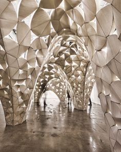 the interior of a building with large wooden balls on it