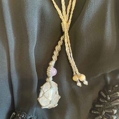 Create more love and joy with this beautiful Macrame Crystal Gemstone Necklace. This beautiful necklace is handcrafted using Aura Rose Quartz Crystal. This necklace is adjustable and can be worn long, short, or in between. It is hand knotted, braided, and fitted to its unique stone and made with a strong, smooth waxed Charcoal Cord. Aura Rose Quartz is Rose Quartz that is bonded with precious metals to create a beautiful rainbow aura effect. Aura Rose Quartz opens the heart and mind to new oppor Artisan Necklace With Adjustable Cord For Healing, Spiritual Lariat Crystal Necklace For Gift, Ethereal Adjustable Necklaces For Gifts, Handmade Adjustable Moonstone Beaded Necklace, Holistic Jewelry With Adjustable Cord For Meditation, Spiritual Adjustable Necklace For Festivals, Bohemian Resizable Necklace For Gift, Mystical Adjustable Crystal Necklace With Natural Stones, Adjustable Rose Quartz Crystal Necklace