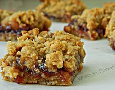 several pieces of dessert sitting on top of a white paper towel with crumbs