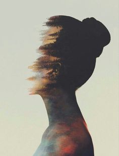 a woman's profile with her hair blowing in the wind