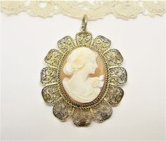 Gold and Sterling silver marked 925  SILVER FILIGREE CAMEO  Oval Pendant A Lady  Handcrafted  antique, vintage, used  in box length: 2 inches, 5 cm A fine gift for life Oval Silver Jewelry For Vintage Events, Engraved Oval Jewelry For Vintage Events, Antique Oval Jewelry For Vintage Events, Vintage Oval Necklaces With Intricate Design, Ornate Cameo Jewelry For Vintage Events, Antique Gold Oval Filigree Necklace, Victorian Oval Jewelry For Vintage Events, Oval Vintage Jewelry For Vintage Collection, Vintage Oval Jewelry As A Gift