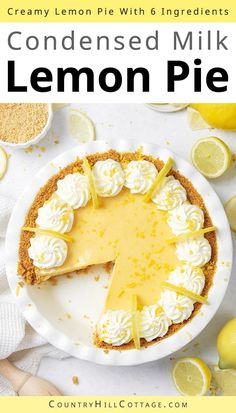 a lemon pie on a white plate surrounded by lemons and whipped cream, with the words condenseed milk lemon pie