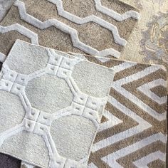 several different types of rugs with white and brown designs on them, including one in the middle