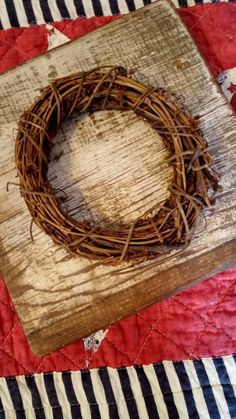 a close up of a piece of wood with a wreath on it