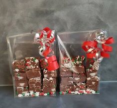 two clear bags filled with brownies covered in candy and bows on top of each other