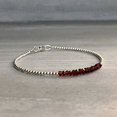 This gemstone bracelet features small genuine Garnet stones. The faceted garnet beads are a beautiful vibrant red hue. This piece is timeless, yet unique. A perfect gift for a birthday or for your Valentine. The tiny round beads frame the faceted gemstones beautifully. At checkout, choose to buy a Garnet bracelet with gold or sterling silver beads. * METAPHYSICAL PROPERTIES OF GARNETS * courage energy love passion self confidence transformation Free gift with every crystal jewelry purchase from Dainty Faceted Beaded Bracelets, Faceted Rondelle Beaded Bracelets As Gift, Minimalist Faceted Rondelle Beaded Bracelets, Faceted Rondelle Crystal Bracelet Gift, Faceted Rondelle Beaded Bracelets, Minimalist Bracelets With Faceted Rondelle Beads, Minimalist Faceted Beads Rondelle Bracelets, Minimalist Rondelle Bracelets With Faceted Beads, Gift Rondelle Faceted Beaded Bracelets