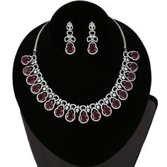 American Diamond bridal collar choker necklace studded with emerald green, ruby red and clear CZ stones encrusted on silver tone rhodium background. Necklace comes with a pair of matching earrings. This is very unique and beautiful Indian Necklace set studded high quality AD stones beautifully decorated work. Stone shape: emerald cut and Pear Necklace Length: 9 inches+ Length of Extender is 9 inches Earring Length: 1.9 inches Contents: 1 Necklace, 2 Earrings Best suitable for Party Wear / Fashio Red Metal Jewelry With Rhinestones, Elegant Red Bridal Necklace With Sparkling Stones, Red Crystal Bridal Necklace For Party, Elegant Red Rhinestone Necklace, Red Crystal Party Necklace, Elegant Jeweled Red Bridal Necklace, Elegant Red Rhinestone Necklace For Formal Occasions, Elegant Red Rhinestone Necklace For Formal Events, Elegant Red Jeweled Bridal Necklace