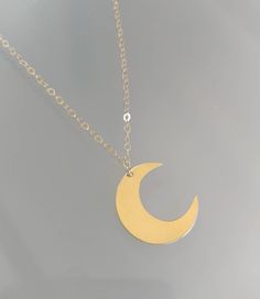 "This beautiful moon and star necklace will shine bright any time of day! The large crescent moon hangs from a sparkly chain with two stars above. The moon is approximately 40mm and the tiny stars are 6mm. The necklace comes in your choice of sterling silver or gold filled and can be hammered or left smooth. Shown in a 30\" length in gold with smooth finish. *Also available in our tiny and medium versions as seen in the last two photos. *If you are unsure of the length you need, or would like to Gold Necklaces With Moon Charm, Gold Necklaces With Sun And Moon Design, Gold Necklaces With Sun And Moon Half Moon Design, Gold Charm Necklace With Moon Phase, Gold Moon Charm Necklaces, Gold Half Moon Charm Necklace With Moon Phase, Gold Moon Phase Charm Necklace, Gold Minimalist Moon Charm Necklace, Gold Half Moon Celestial Necklace