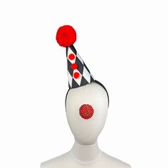 a white mannequin head wearing a black and white hat with red polka dots