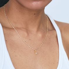 The sweetest mini initial charm adorns our best-selling gold & silver mixed shimmer chain. Layer your initials or your loved ones for a personalized addition to your stack. Choose from 16" or 18" Sterling silver, nickel-free chain with a 5x8mm 24k gold plated brass charm with cubic zirconia detail. Comes packaged in our signature lavender pouch. Dainty Charm Necklaces With Initial Pendant For Everyday, Everyday Tiny Initial Pendant Charm Necklace, Dainty Initial Necklace With Charms, Everyday Initial Necklace For Mother's Day, Gold Charm Necklaces With Letter Beads, Tiny Initial Pendant Necklace For Gift, Gold Jewelry With Letter Beads For Best Friend Gift, Mother's Day Initial Pendant Necklace With Letter Beads, Mother's Day Initial Necklace With Letter Beads