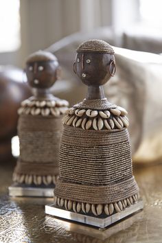 two ceramic figurines sitting on top of a table