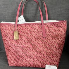 Brand New With Tag Coach Signature Tote Handbag Purse Grain Leather Rouge (Pink) Color Polished Gold Hardware Coach Logo & Medallion On The Front Snap Closure On The Top Interior: One Zip Pocket Approximately 13”-17”L X 11.5”H X 6"W Durable & Roomy Smoke & Pet Free Home Retail Price $398+Tax Please See My Entire Collection . Monogram Canvas Shopping Bag With Branded Hardware, Tan Monogram Canvas Bag For Shopping, Tan Monogram Canvas Shopping Bag, Large Capacity Monogram Canvas Bag, Monogram Canvas Shopping Bag, Daily Use Monogram Canvas Shoulder Bag With Logo, Luxury Large Capacity Pink Shoulder Bag, Monogram Canvas Satchel With Logo, Pink Monogram Canvas Shoulder Bag For Shopping