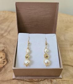 About this product: Our Freshwater Pearl Earrings are a dainty, opulent accessory that dangles lightly from your ears. Pearls are used as the main centerpiece to this lovely set. It is then accented by 14k Filigree Beads and 925 Gold Earring wires. We've made these earrings with lightweight and allergen-friendly materials, so you can have your own beauty naturally accented without sacrificing any comfort. This product will come in the displayed gift box along with a polishing cloth.   What we lo Freshwater Pearl Earrings, Earring Wires, Hypoallergenic Jewelry, Earrings Elegant, Freshwater Pearls Earrings, Gold Earring, Gold Beads, Gift For Women, Jewelry Gift