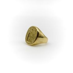 This 18k gold Tiffany & Co. Larter & Sons signet ring is hand carved with a heraldic family crest. The crest has a shield with three bell-like shapes sprouting flowers. Above the shield is a knight’s helmet topped with a feather and surrounded by scrolling foliate. The classic design of the crest suggests royalty and valor.  Larter & Sons was founded in 1865 and was renowned for their exquisite craftsmanship of men’s accessories. They expanded to include women’s jewelry in the early 20th century, using intricate techniques such as guilloche and enamelwork, and incorporating motifs inspired by nature. They collaborated with Tiffany & Co. to make jewelry such as cufflinks and signet rings. Tiffany & Co. would often consign well-known brands of the highest quality, including Larter & Sons. Luxury Carved Yellow Gold Signet Ring, Classic Yellow Gold Engraved Ring With Coat Of Arms, Classic Yellow Gold Signet Ring With Intaglio, Gold Oval Signet Ring With Coat Of Arms, Formal Gold Signet Ring With Coat Of Arms, Classic Ceremonial Engraved Intaglio Ring, Luxury 14k Gold Signet Ring With Intaglio, Classic Oval Signet Ring With Coat Of Arms, Classic Ceremonial Signet Ring With Intaglio