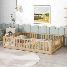 a baby's room with a wooden crib in the middle and a painting on the wall