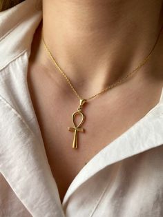 "It can be layered with other necklaces. 18K gold plated 925 sterling Silver necklace. It comes in our branded jewelry box and jewelry cleaning cloth, making it a great gift for her. The Ankh is one of the most popular symbols from ancient Egypt, known as \"the key of life\" or the \"cross of life\". Egyptians believed that one's earthly journey was only part of an eternal life, the ankh symbolizes both mortal existence and the afterlife.  It is a very nice option for those looking for a meaning Gold Cross Chain Necklace Elegant Style, Gold Plated Chain Necklace Gift, Elegant Gold Necklaces With Cross Pendant, Elegant Gold Cross Pendant Necklaces, Elegant Cross Pendant Necklace As Gift, Elegant Cross Pendant Necklace For Gift, Elegant Gold Cross Chain Necklace, Spiritual Gold Plated Cross Pendant Necklace, Gold Plated Cross Pendant Necklace Spiritual Style