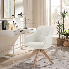 a white chair sitting in front of a desk