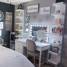 a bedroom with a bed, desk and mirror on the wall next to a window