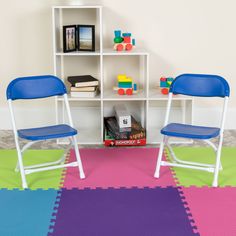 two children's chairs sitting in front of a bookshelf on the floor