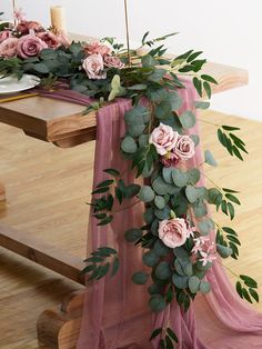 the table is decorated with pink flowers and greenery