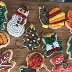 decorated cookies are arranged on a wooden table