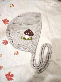 a knitted hat with a brown mushroom on it