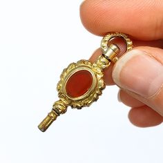 Crafted with meticulous attention to detail, this antique gold plated fob key was designed to accompany your cherished pocket watch. The rich, warm tones of the red agate stones create a striking contrast against the lustrous gold plating.  - Weight 4.25g - Measurements 3.7cm x 1.8cm  - box for display only All our items are vintage so will show some signs of wear/ageing but have been sympathetically cleaned and polished so they look beautiful for our buyers. Enjoy peace of mind with our expert Gold Necklace Pendant, Red Agate, Key Pendant, Gold Pendant Necklace, Agate Stone, Jewelry Bags, Key Fob, Necklace Pendant, Pocket Watch