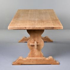 a wooden table with a cross at the top and two legs on each side, against a gray background