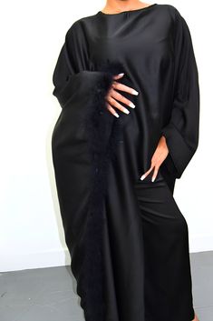 Embrace timeless elegance with our exquisite Satin Abaya Co-Ord Set. This stunning two-piece ensemble features a luxurious, soft-flowing satin fabric that drapes beautifully and flatters your figure. The elegant abaya boasts a modest silhouette, perfect for everyday wear or special occasions. The highlight of this set is the exquisite fur trim. This touch of luxury adds a touch of sophistication and warmth to the design, making it perfect for cooler evenings or formal events. Key Features Luxurious Satin Fabric: Experience the soft, smooth feel of premium satin that flatters your form. Elegant Abaya Silhouette: This modest design offers full coverage while maintaining a stylish and graceful drape. Delicate Fur Trim: Elevate your look with a touch of luxury and warmth. Two-Piece Co-Ord Set: Elegant Evening Thobe In Maxi Length, Elegant Floor-length Party Thobe, Elegant Long Sleeve Wedding Niqab, Long Sleeve Thobe For Eid Evening, Elegant Long Sleeve Kaftan For Eid, Elegant Maxi Length Niqab For Eid, Elegant Satin Abaya For Party, Evening Satin Maxi Abaya, Evening Satin Maxi-length Abaya