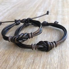 "These lovely bracelets are made with waxed cord, brown rubber spacers, and sterling silver links. Designed for couples If you choose \"Custom Initials Set\" Please leave me a note at checkout with the initials. Both bracelets are adjustable. One closes to 6\" and opens to 9\", the other closes around 7\" and opens to 10\". Includes Gift Box if you choose the set option in the dropdown menu." Personalized Adjustable Beaded Bracelets For Promise, Brown Adjustable Band Bracelet Jewelry, Brown Resizable Jewelry For Gifts, Couples Adjustable Friendship Bracelets, Adjustable Couples Friendship Bracelets, Adjustable Brown Jewelry For Friendship, Brown Charm Bracelet Gift, Adjustable Couples Bracelets As Gifts, Handmade Adjustable Bracelets For Anniversary