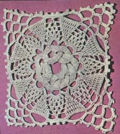 a white doily on a pink background