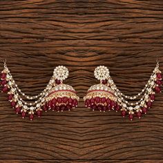 Add a regal look to your outfits with our Rani Pankhuri Earrings. These Gold-Plated beauties feature Kundan with Rani beads and a stunning Kaan chain design. Specifications Materials used: Kundan, Rani beads Length: 7.5 cm, Width: 6 cm Weight: 8.1 grams At Romikas, we pride ourselves on the craftsmanship and high quality of our jewelry, designed to enhance your natural beauty. Please contact us with any questions. Temple Jewelry Chandbalis With Latkans, Temple Jewelry Style Chandbalis With Latkans, Temple Jewelry Jhumkas With Latkans For Diwali, Diwali Temple Jewelry Jhumkas With Latkans, Traditional Cutdana Dangle Jhumkas, Temple Jewelry Style Jhumkas With Latkans For Festivals, Temple Jewelry Jhumkas With Latkans For Festivals, Latkan Dangle Earrings For Puja, Traditional Chandbali Jhumkas With Latkans