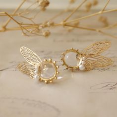 Experience the magic with our fairy wing earrings. Made from 18K gold with butterfly wing designs, these unique pieces add a whimsical touch to any outfit. Perfect for those who love fantasy-inspired jewelry. Transform your look with our fantasy inspired jewelry. Crafted from luxurious 18K gold, these earrings blend elegance and whimsy. Ideal for those seeking cute and unique accessories. Embrace ethereal elegance with our butterfly wing earrings. These 18K gold pieces feature a delicate design, perfect for adding a touch of fantasy to your style. ** Jewelry Care Guide ** Please keep it away from chemicals, store it in a dry place, avoid dropping, and seal it when not in use.  Alloy: Avoid contact with water.  18K gold and 925 silver: Clean regularly with a silver cloth.  Natural pearls: A Gold Fantasy Jewelry, Fantasy Winged Jewelry Gift, Gold Fantasy Handmade Earrings, Handmade Gold Fantasy Earrings, Whimsical Gold Jewelry For Pierced Ears, Gold Handmade Fantasy Earrings, Handmade Gold Wing-shaped Earrings, Fairy Style Jewelry With Matching Earrings Gift, Elegant Winged Earrings For Gift