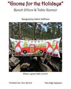 a red truck pillow sitting on top of a pile of tree trunks with the words gnomes for the holidays below it