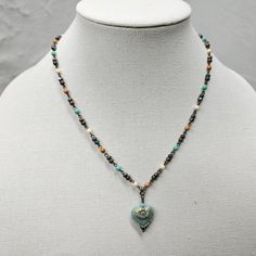 A beautiful, unique Czech Beaded Necklace that is eye-catching! Give this wonderful piece of jewelry as a gift for your mom, wife, or girlfriend.  SIZE  *Necklace Length - 18-24 inches *Pendant height - 1 inches *Pendant width - ¾ inches  ITEM DETAILS  *Material - Glass AQUA HEART WITH 3 COLOR CHAIN  *       A beautiful pressed Czech glass matte aqua opaque heart with a complementing goldish wash finish. *The chain is a 4mm multi-color beaded Czech chain with antique brass wire connecting the ch Heart-shaped Colorful Beads Necklace For Jewelry Making, Elegant Heart-shaped Colorful Beads Jewelry, Elegant Heart-shaped Jewelry With Colorful Beads, Elegant Heart-shaped Colorful Beaded Jewelry, Heart Beads Pendant Necklace For Gifts, Heart-shaped Colorful Beads Jewelry For Gifts, Heart Pendant Jewelry With Colorful Beads For Gift, Heart Beads Charm Necklace For Jewelry Making, Colorful Beads Heart Shaped Beaded Necklace Gift