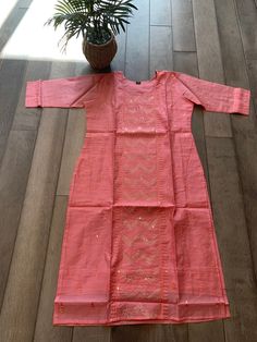 This is a premium quality Chanderi mixed silk kurti that can be worn casually on jeans or for a small party. The kurti comes with elegant sequin work on the vertical panel on the body, that glitters elegantly from the intricate embroidery work. Size of kurti: XL (42 inches bust) Traditional Slub Silk Kurta With Mirror Work, Diwali Slub Silk Kurta With Dabka Work, Festive Kurta With Mirror Work In Slub Silk, Festive Slub Silk Kurta With Mirror Work, Festive Slub Silk Kurta With Chikankari Embroidery, Embroidered Slub Silk Kurta For Navratri, Traditional Slub Silk Long Sleeve With Mirror Work, Bollywood Style Slub Silk Kurta With Resham Embroidery, Long Sleeve Sharara With Mirror Work In Slub Silk