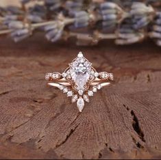 an engagement ring on top of a piece of wood