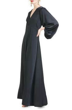 Billowed sleeves add a dramatic touch to this satin gown styled with a sweeping skirt. 62" length V-neck Long sleeves Lined 100% polyester Dry clean Imported Knee Length Evening Dress, Empire Waist Gown, Sachin Babi, Evening Dresses With Sleeves, Black Satin Dress, Long Balloons, Satin Gown, Dress Home, Gowns With Sleeves