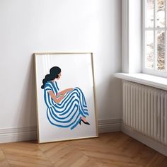 a painting is sitting on the floor next to a radiator in a white room