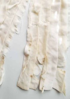 torn white fabric with holes in it