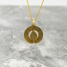 Crafted for the discerning Muslim woman, the Diwani Ayatul Kursi Necklace is a true masterpiece of Islamic jewelry. Made from high-quality 925 sterling silver and elegantly plated with 18K gold, this pendant is a blend of sophistication and faith. The intricate design featuring the Ayatul Kursi from the Quran adds a spiritual touch to any outfit. Whether worn as a daily reminder of faith or as a special gift, this necklace embodies both style and devotion. Elevate your jewelry collection with this symbolic piece that celebrates both beauty and faith in a subtle and elegant manner. Size of Pendant: 1x1" | 2.5x2.5 cm Weight of Pendant (Without Silver Chain): 0.14 oz | 3.8 gr Material of Pendant: 18K gold plated on Hypoallergenic 925 sterling silver. Length of Chain : 14 in - 35 cm | 16 in - Amulet Style Engraved Necklace For Anniversary, Engraved Amulet Necklace For Anniversary, Spiritual Polished Wedding Necklaces, Symbolic Round Necklace With Intricate Design, Amulet Necklace With Polished Finish For Anniversary, Brass Necklaces With Intricate Design As Gift, Brass Necklaces With Intricate Design For Gifts, Intricate Brass Necklaces For Gift, Symbolic Intricate Design Necklace For Gift