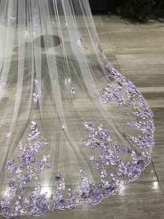 a veil with purple flowers on it