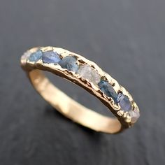 a gold ring with blue and white stones