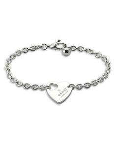 Gucci Sterling Silver Trademark Heart Charm Bracelet Luxury Sterling Silver Heart Bracelet For Gift, Gucci Sterling Silver Jewelry With Heart Charm, Luxury Sterling Silver Bracelets For Valentine's Day, Luxury Sterling Silver Heart Bracelet For Anniversary, Elegant Silver Bracelet With Logo Charm, Classic White Gold Jewelry With Logo Charm, Luxury Silver Bracelets For Valentine's Day, Designer Jewelry Bracelet With Logo Charm, Designer Logo Charm Bracelet Jewelry