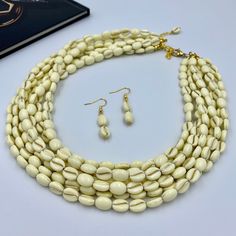 Elevate your style with our Elegant Ivory White Multi Strand Necklace. This chunky beaded statement piece is handcrafted with multiple layers of smooth ivory beads, offering a sophisticated touch to any outfit. Perfect as a thoughtful gift for her, this necklace is designed to impress, making it an exquisite addition to any woman's jewelry collection. This is a handcrafted necklace, uniquely designed with attention to every detail. - Necklace length is 17.5" long, 7 STRANDS plus additional 4 inc Luxury White Artisan Necklace, Luxury White Beaded Statement Necklaces, Luxury White Multi-strand Necklace, Luxury Multi-strand Jewelry Statement Piece, Luxury White Multi-strand Beaded Necklaces, Luxury White Artisan Beaded Necklaces, Luxury Handmade Long Necklace For Gift, Luxury Long White Beaded Necklaces, Luxury Statement Multi-strand Beaded Necklace