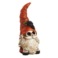 a ceramic figurine of a skeleton wearing a red hat